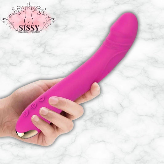 Vibromasseur en silicone rose tenu dans une main avec boutons de contrôle Sissy Transformation Shop